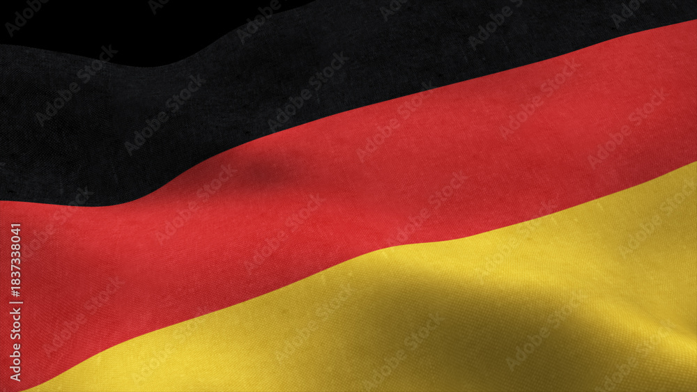 Naklejka premium German flag fluttering in the wind isolated on black background