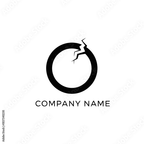 Cracked black circle logo design with company name text.