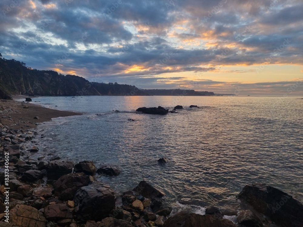 Fototapeta premium Panoramic view from the top of the cliffs at the north atlantic coastline of Spain at sunset with misty atmosphere 