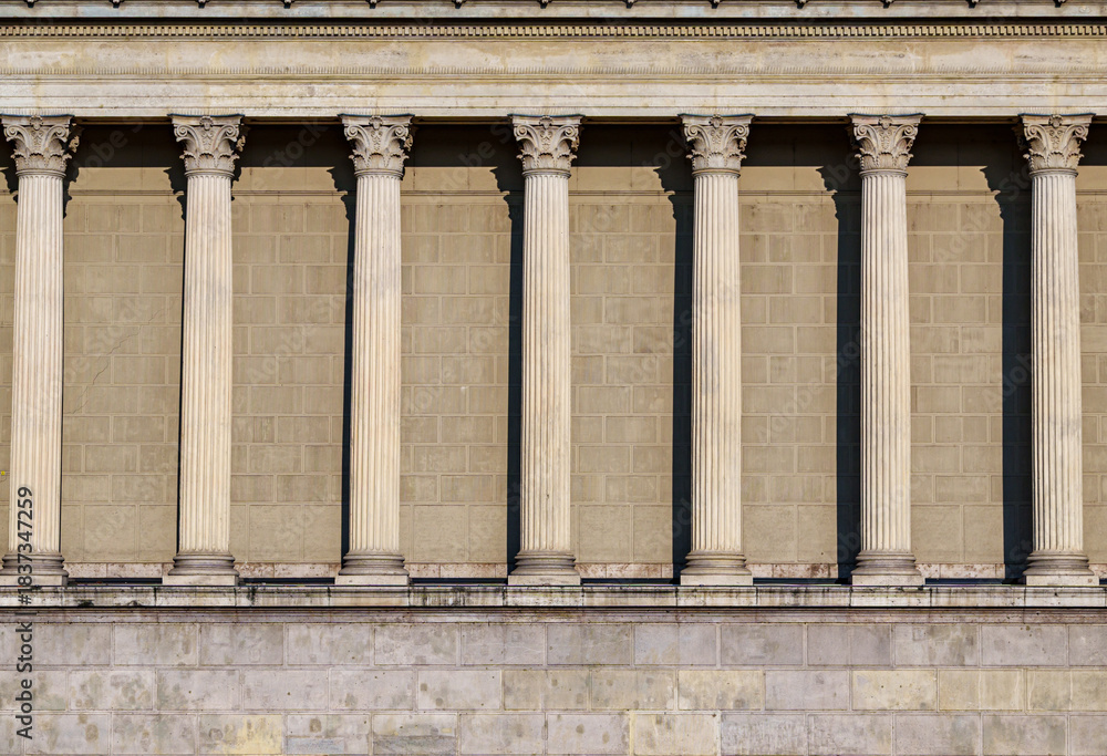 Naklejka premium Columns and wall of an old building as an abstract background, architectural details