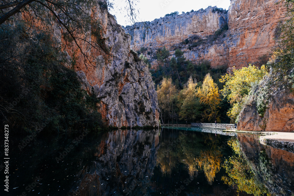 Fototapeta premium Monasterio de Piedra canyon lake reflecting autumn foliage in Zaragoza, Spain