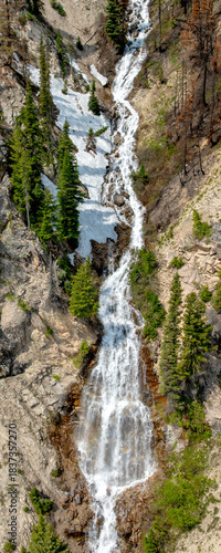 Long waterfall in a pano crop flows through a small canyon