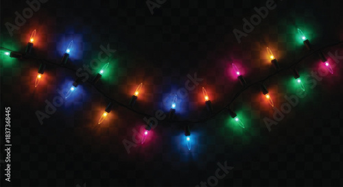 A close-up view of a string of incandescent or LED Christmas lights featuring various colors such as red, green, blue, and magenta, illuminated against a deep black, checkered background.
