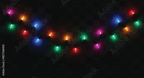 A close-up view of a string of incandescent or LED Christmas lights featuring various colors such as red, green, blue, and magenta, illuminated against a deep black, checkered background.