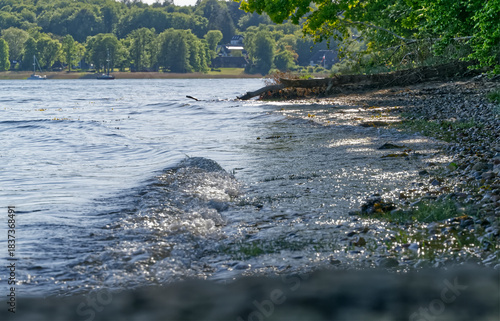 Fototapeta Naklejka Na Ścianę i Meble -  Gentle Baltic Sea waves rolling onto the natural shoreline at Kollund beach