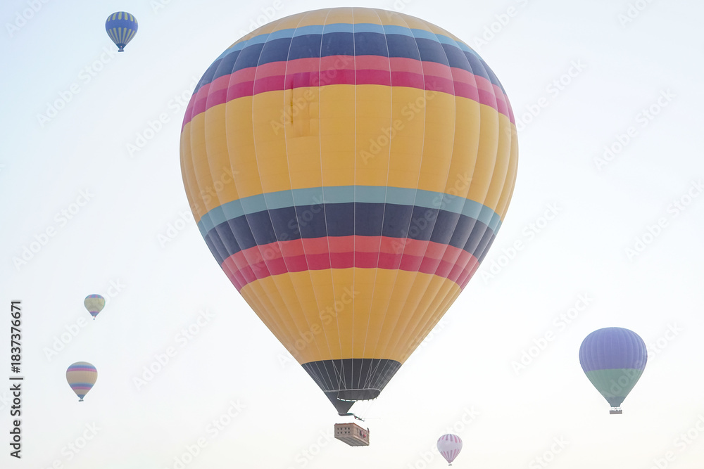 Fototapeta premium Hot Air Balloon over Cappadocia Valleys in Nevsehir, Turkiye