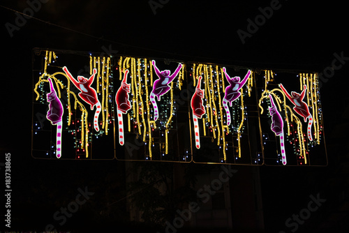Yellow Christmas lights with lemur figures on a street in Madrid, Spain.
