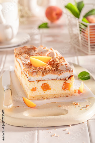 Fresht and sweet peach cheesecake with meringue, foam and fruits.