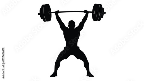 Silhouette of a weightlifter successfully completing an overhead barbell lift