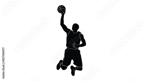 Silhouette of a basketball player in mid air preparing to dunk the ball