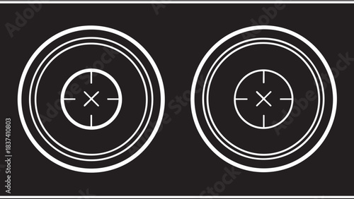 A pair of white circular targets on a black background viewed from a straight-on perspective