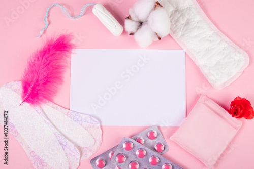 Set of feminine hygiene products for menstruation. Sanitary pads, tampons, pills on pink background. Womens health concept. Copy space.