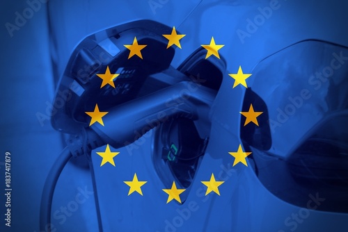 Close up car charging with the European flag as background.