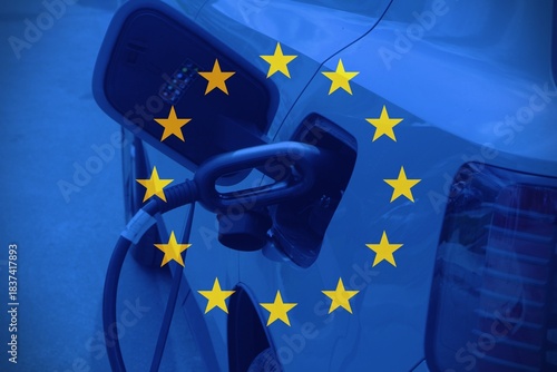 Close up car charging with the European flag as background.