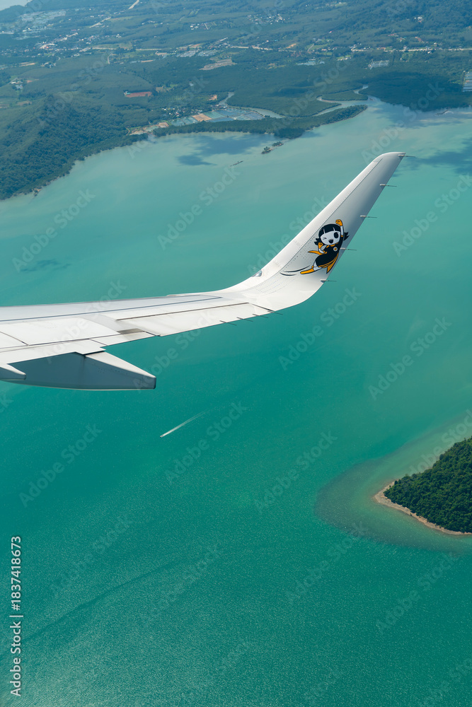 Fototapeta premium Scoot Airbus A321neo in a right turn over the coast of Phuket.