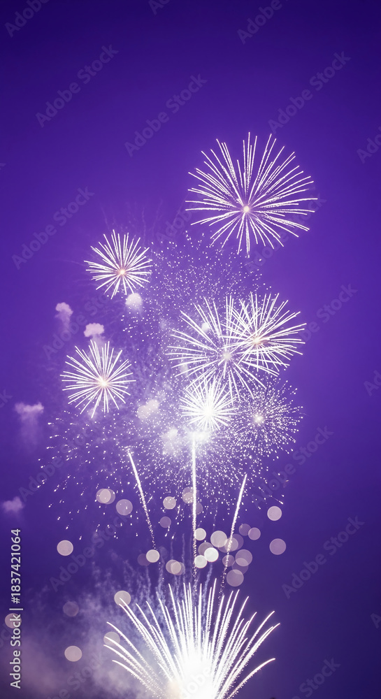 Fototapeta premium Explosion of white fireworks against a purple sky, creating a festive visual, representative of celebration, achievement, or event climax, perfect for backgrounds