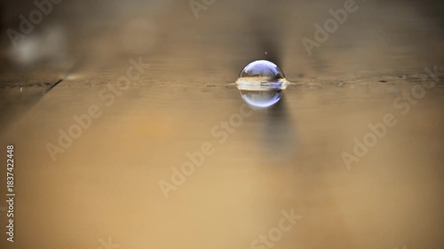 Raindrops are dripping onto the board surface and splashing