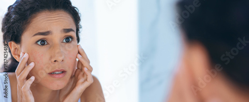 Konstfotografi A woman stands in front of the bathroom mirror, examining her skin closely