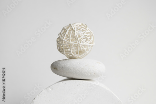A balanced set of pieces made from natural materials— a decorative ball, a stone, and a plaster sphere. Authentic natural life in the trendy color of 2026.