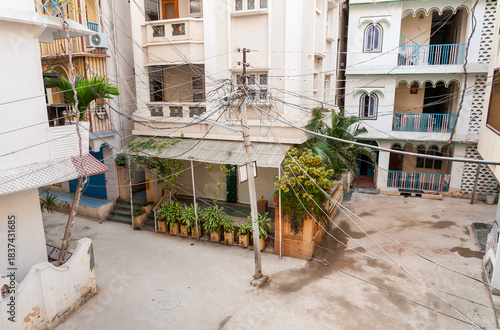 Street view with an electric pole positioned in the center of the road in Puttaparthi, Andhra Pradesh, India