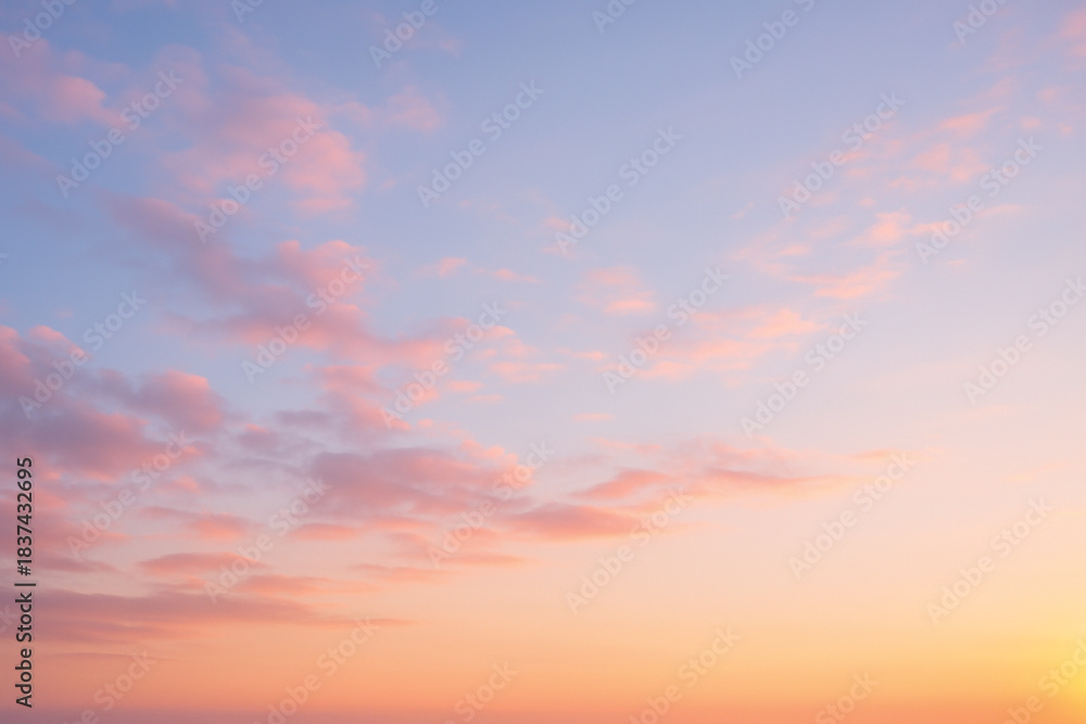 Fototapeta premium Soft Pastel Clouds at Sunrise with Warm Golden Light