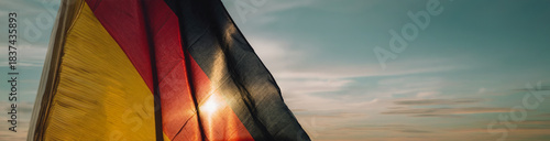 4K HD National flag Background  - The German flag waving proudly in the wind with the sun shining behind it.