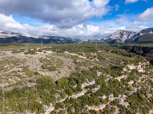 Lush valley with mountains and transmission lines in Mentese, Mugla - Turkey