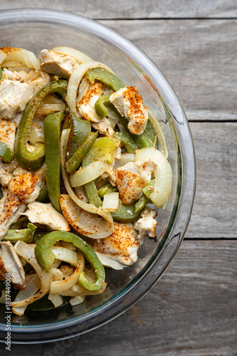 Sheet pan chicken fajitas with sliced onions, green bell peppers, and seasoned chicken arranged on a baking tray. Fresh, simple, and perfect for meal prep or easy dinner recipes.