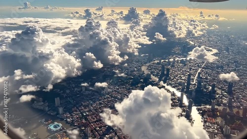 Aerial View Of A Dense Cityscape Beneath Dramatic Cumulus Clouds At Golden Hour Sunlight Streaming Through Window