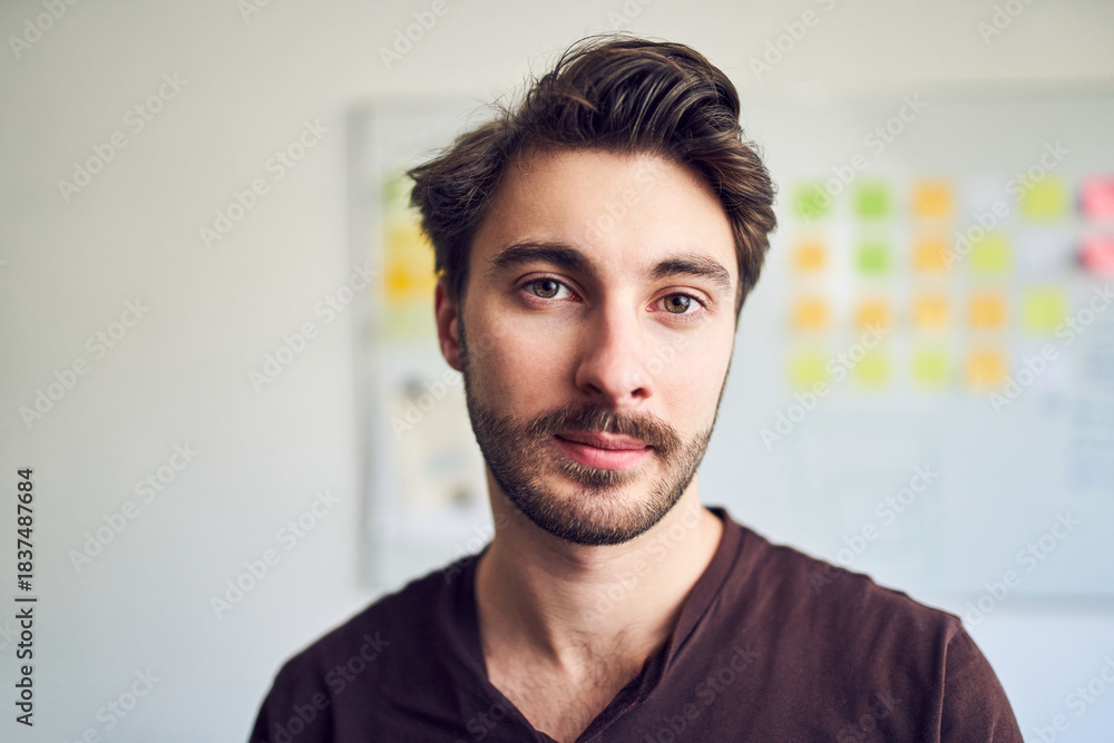 Fototapeta premium Portrait of confident young man in office