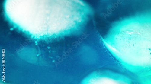 Macro shot of ice cubes inside a blue cocktail