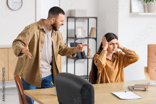 Young man screaming at his ...