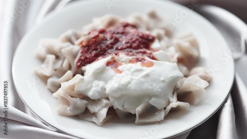 Close-Up of Turkish Manti Dumplings on a White Plate