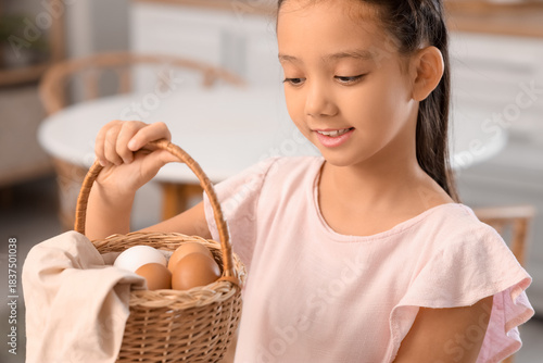 Cute Asian girl with basket...