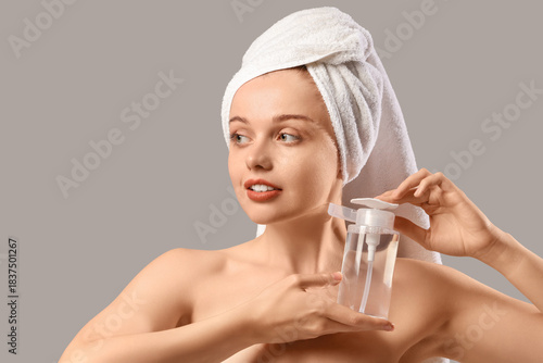 Young woman with bottle of ...