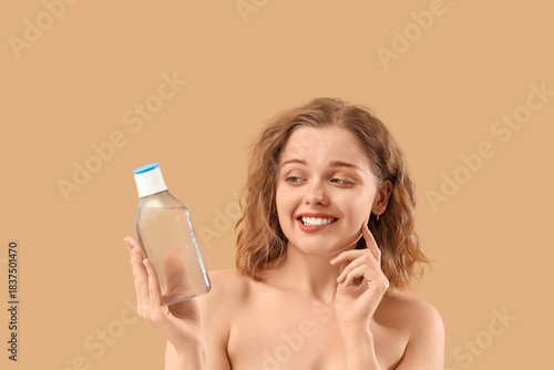 Young woman with bottle of ...