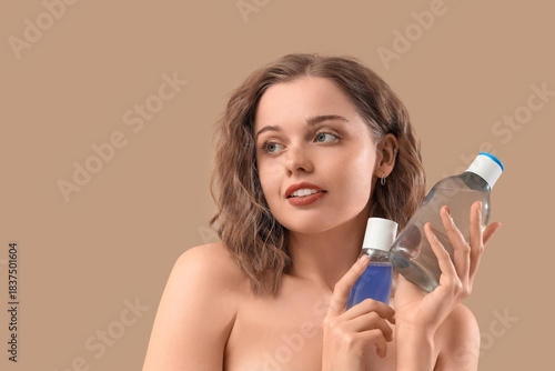 Young woman with bottles of...