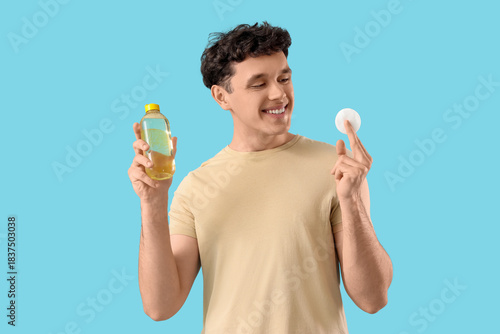 Young man with bottle of mi...