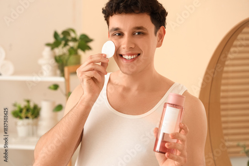 Young man with bottle of mi...