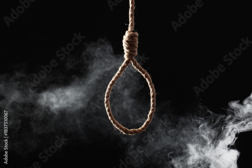 Fotografija Hanging rope with loop and smoke on dark background
