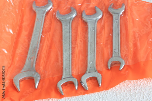 Close-Up of Wrenches in an Orange Container