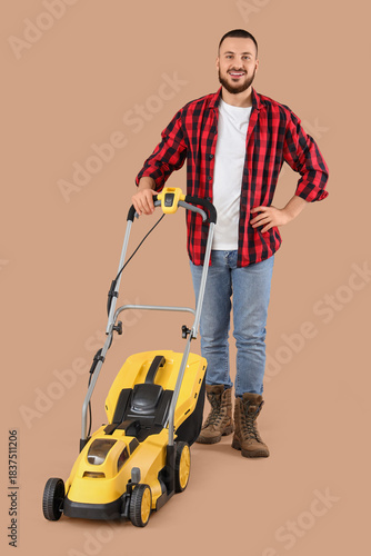 Young man with lawn mower o...
