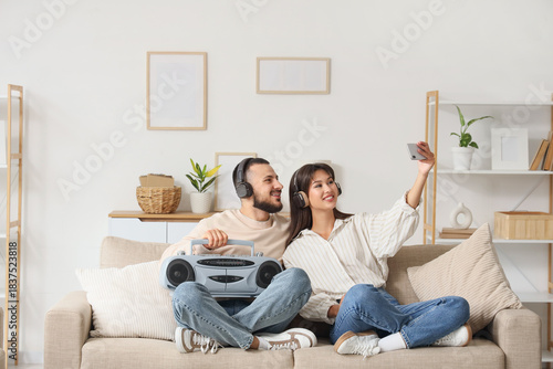 Young couple in headphones ...