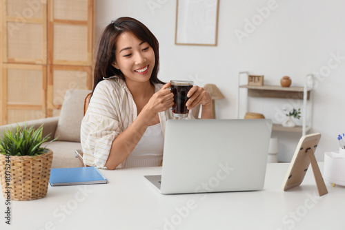 Young Asian woman with cup ...