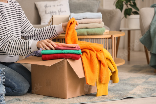 Young woman packing stacks ...