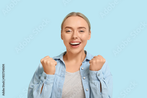 Happy young woman celebrati...
