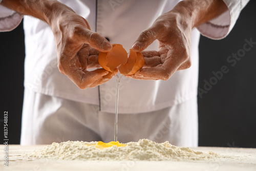 Young chef preparing dough ...