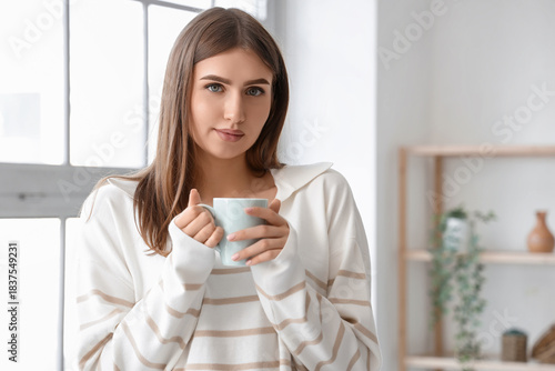 Young woman with cup of hot...