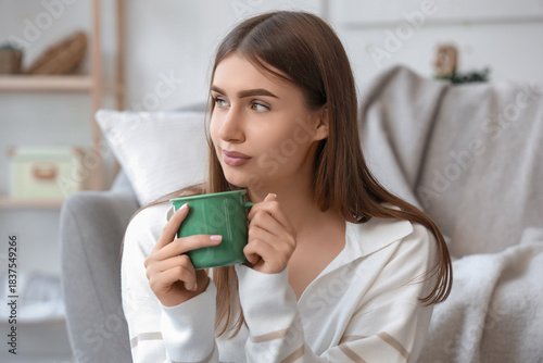 Young woman with cup of hot...