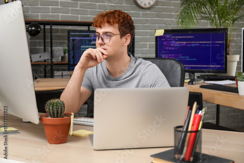 Male programmer working wit...